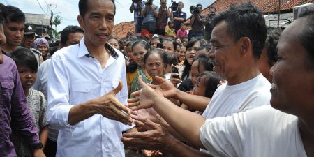 Indonesian President Joko “Jokowi” Widodo shaking hands with people on the street