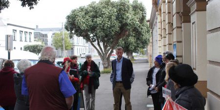 Australian Trade Minister Dan Tehan standing on the street talking with a group of people