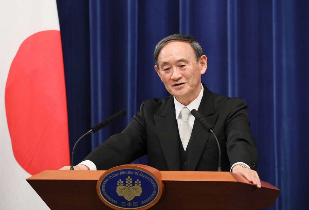 Prime Minister Yoshihide Suga standing at a podium