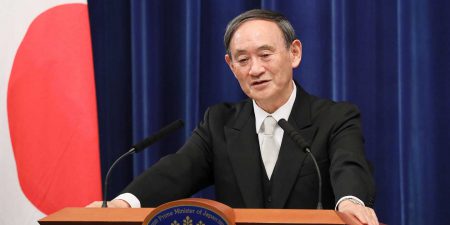 Prime Minister Yoshihide Suga standing at a podium