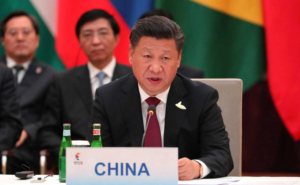 Chinese President Xi Jinping sitting at a table