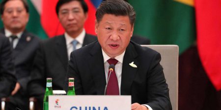 Chinese President Xi Jinping sitting at a table