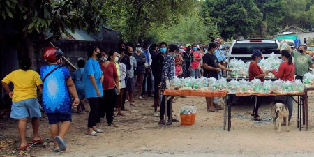 Persons in Thailand in line for free food during the covid lockdowns