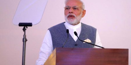 Indian Prime Minister Narendra Modi standing at a podium