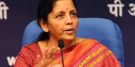 Indian Finance Minister Nirmala Sitharaman speaking at a microphone