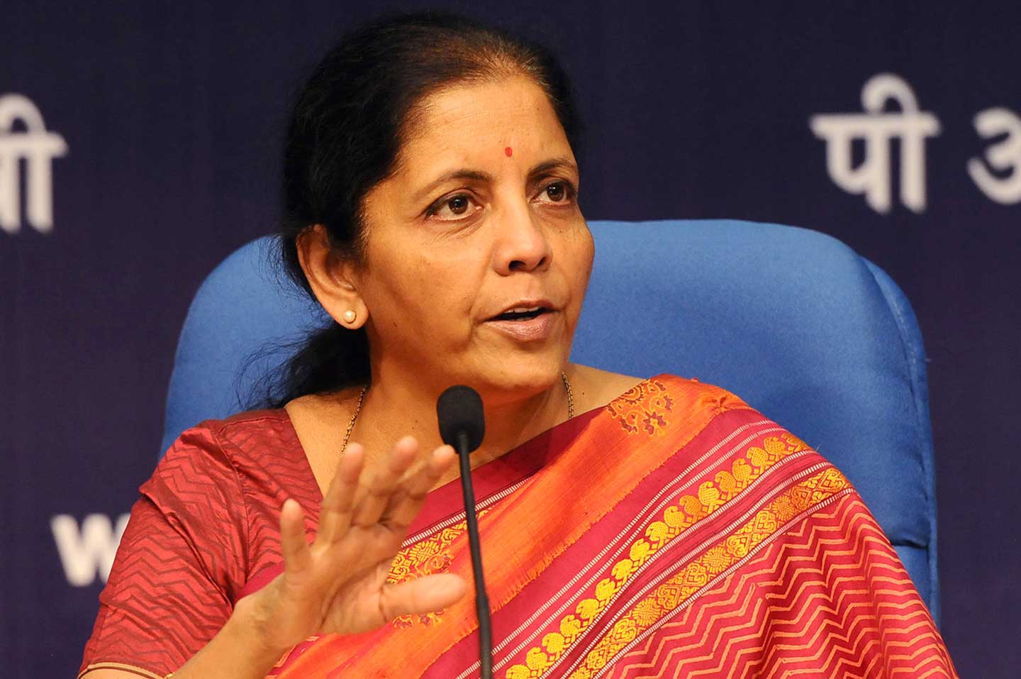 Indian Finance Minister Nirmala Sitharaman speaking at a microphone