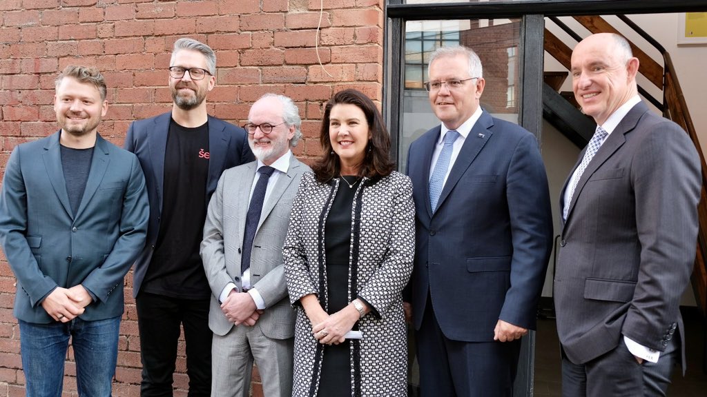 Jane Hume standing with Scott Morrison and others against a brick wall
