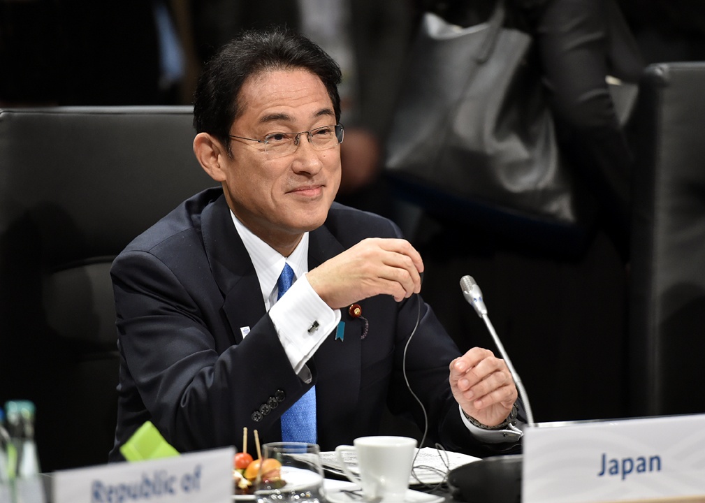 Japanese Prime Minister Fumio Kishida speaking at a microphone
