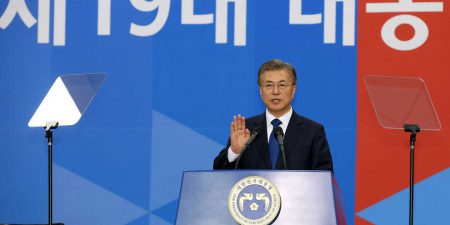 Moon Jae-in speaking at a podium surrounded by teleprompters