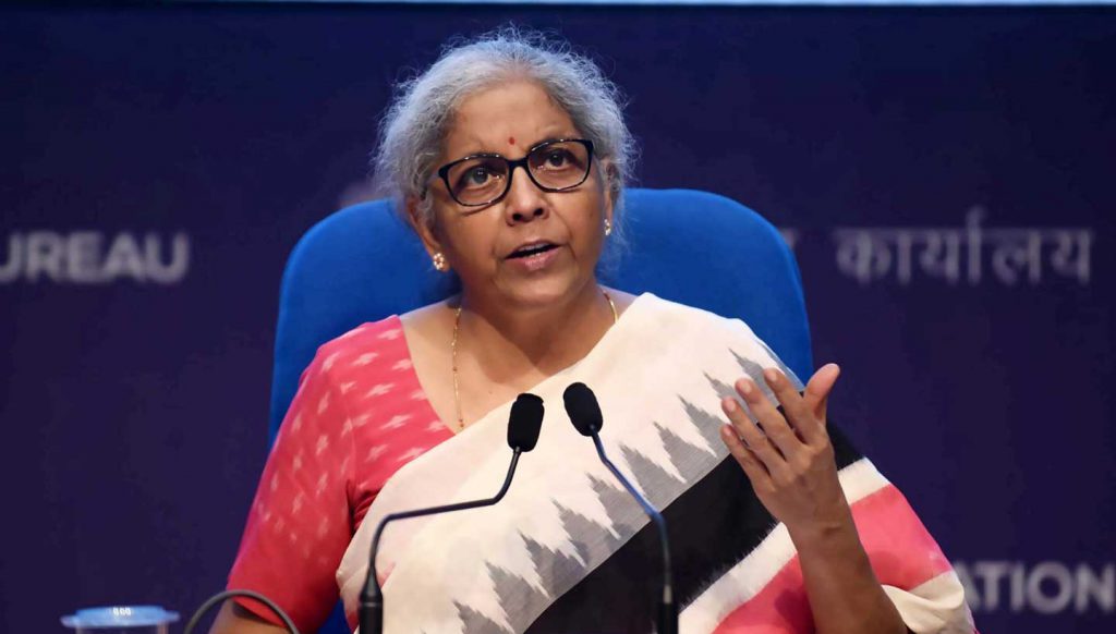 Nirmala Sitharaman speaking at two microphones
