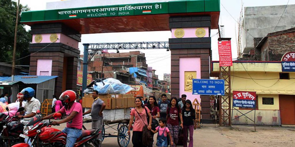 People crossing the border of Nepal and India