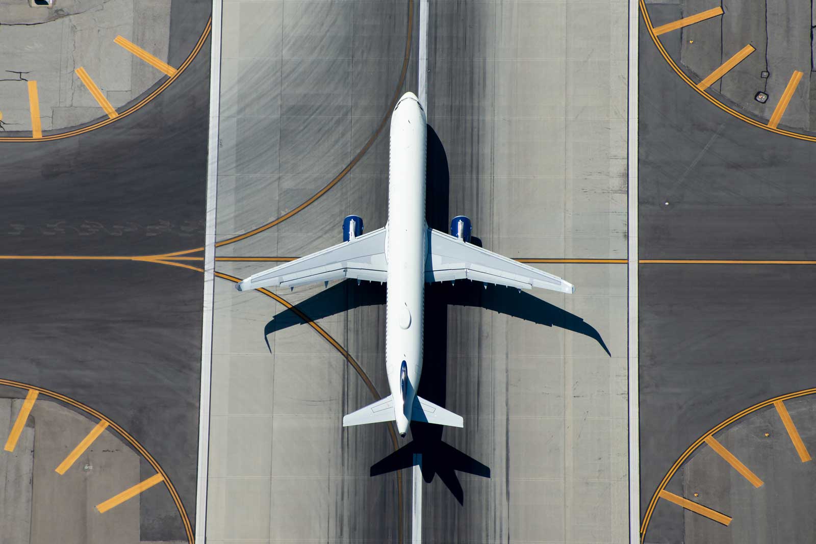 A large plane on the runway taken from directly overhead