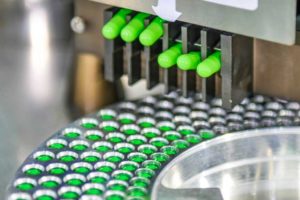 Pill capsules being manufactured