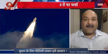 Ratan Shrivastava appearing on TV next to an image of a rocket