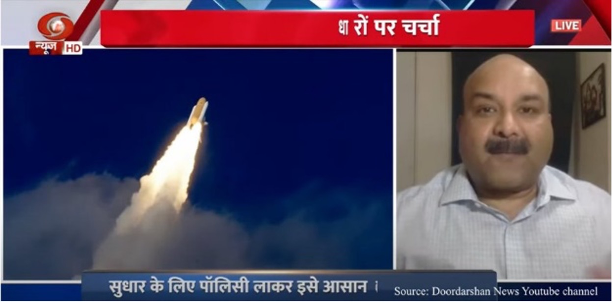 Ratan Shrivastava appearing on TV next to an image of a rocket